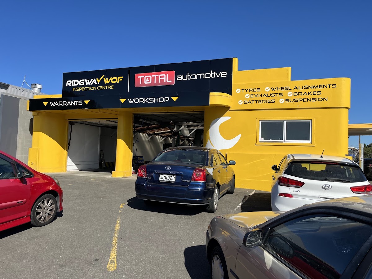 The yellow WOF centre building with its services list